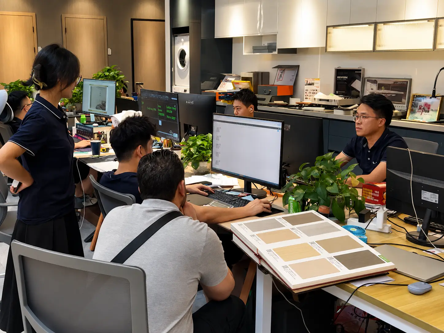 Multi-category building material coordination meeting with drawings and samples
