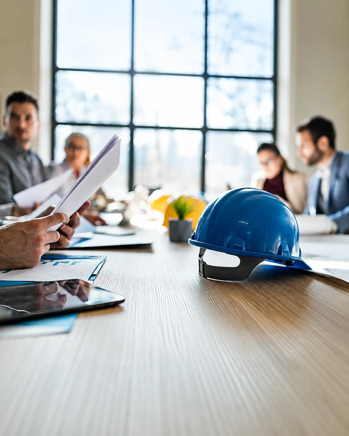 Project owner reviewing drawings and a building material procurement scope